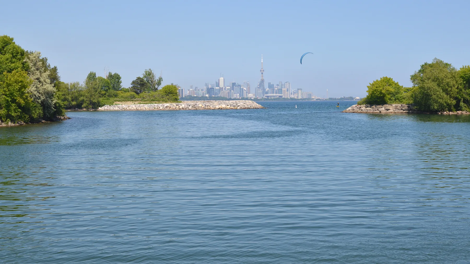 Mimico Creek at Humber Bay Park West, with urban buildings and trees along the water